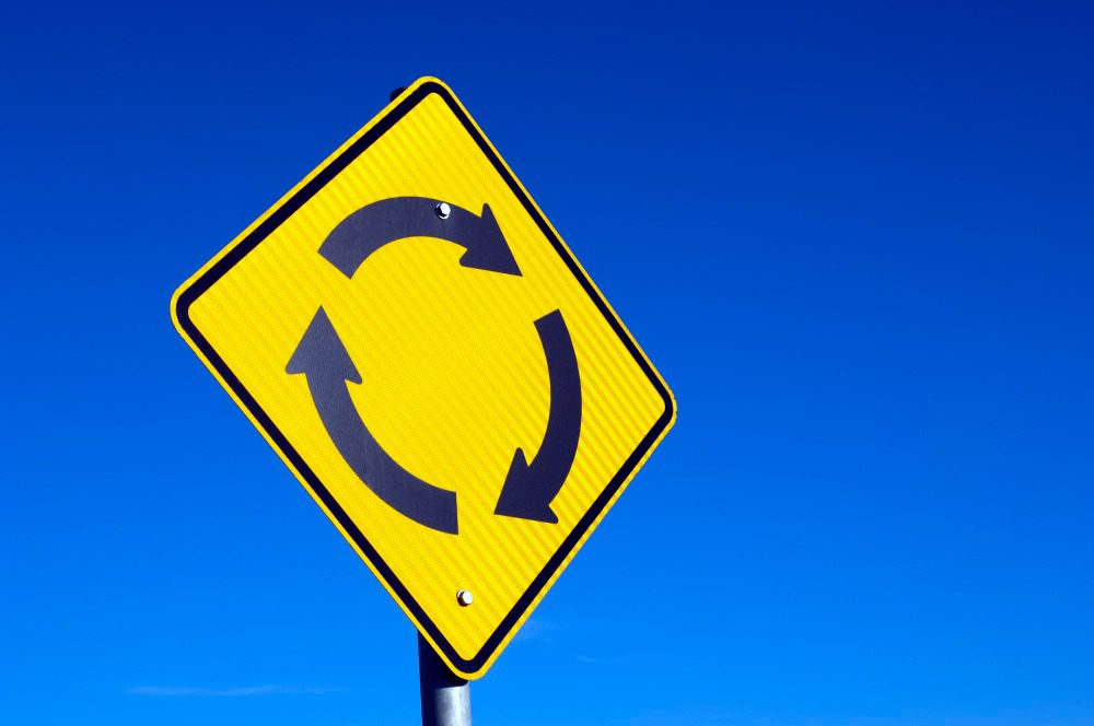 recycle concept roundabout sign against blue sky